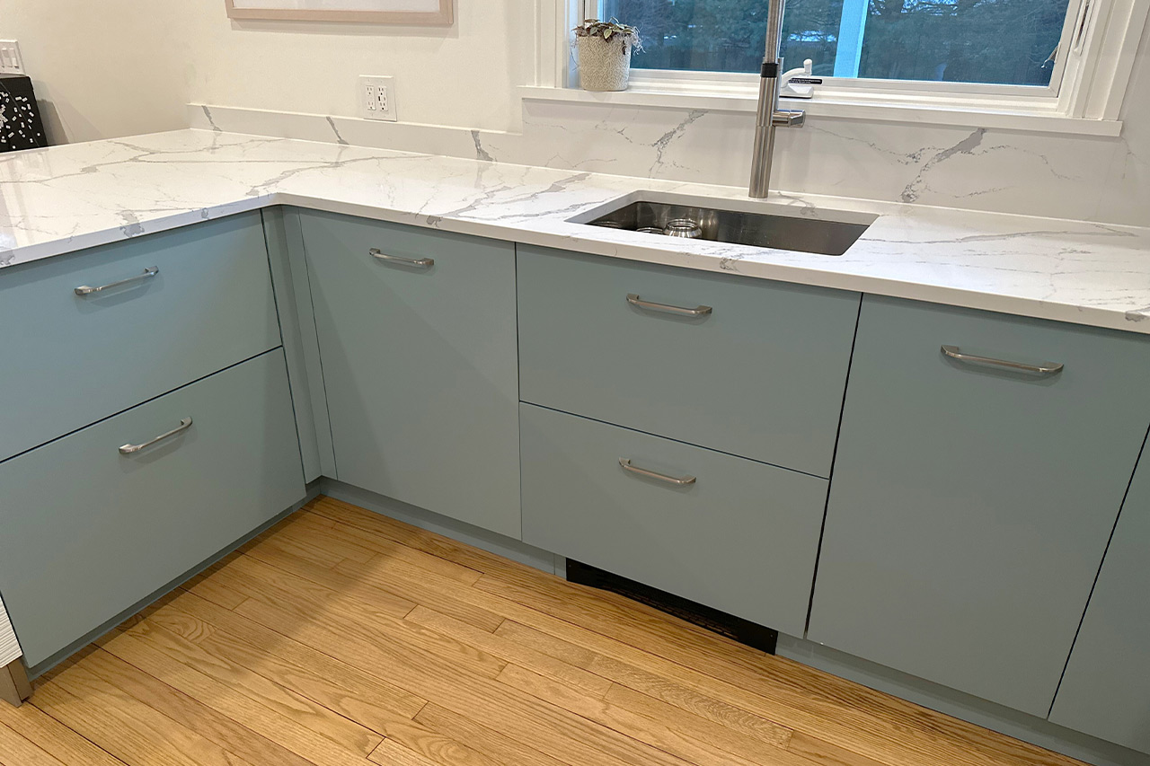 full white slab countertop - stainless steel sink