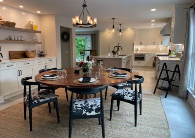 Wood grain melamine Kitchen Island, Compac Unique Countertop, Matte Black Hardware, ROHL Luxe Kitchen Faucet, Dinner Table, Hanging Lights