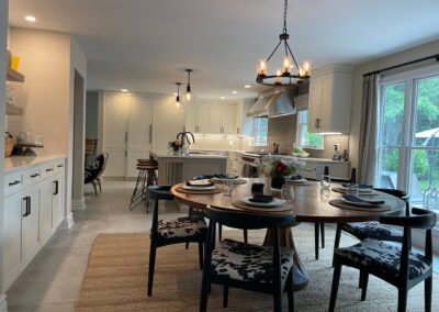 Wood grain melamine Kitchen Island, Compac Unique Countertop, Matte Black Hardware, ROHL Luxe Kitchen Faucet, Dinner Table, Hanging Lights